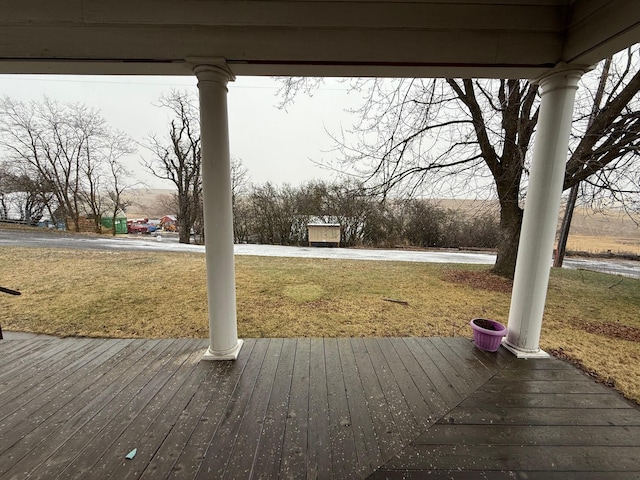 wooden terrace featuring a yard