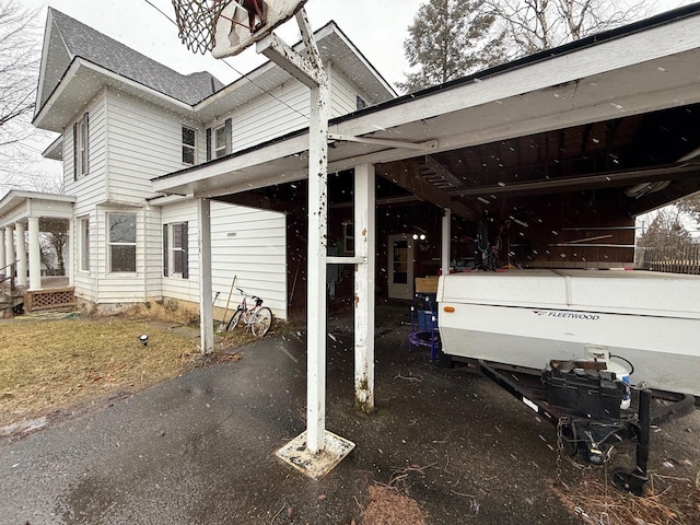 view of property exterior with a carport