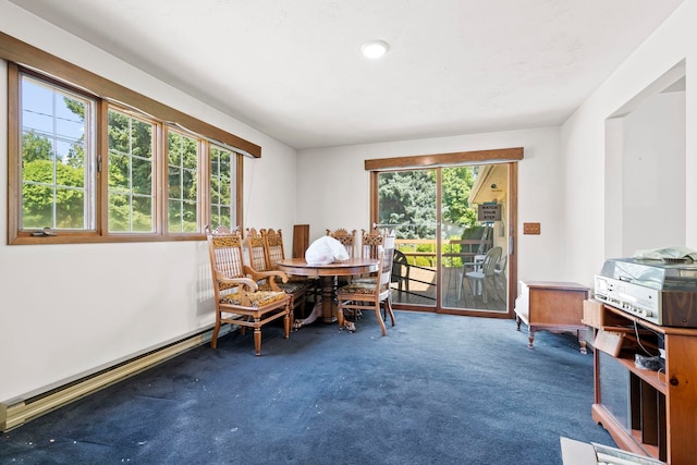 dining room with a baseboard radiator, carpet floors, and a wealth of natural light