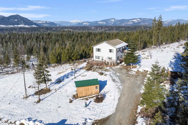 snowy aerial view featuring a mountain view