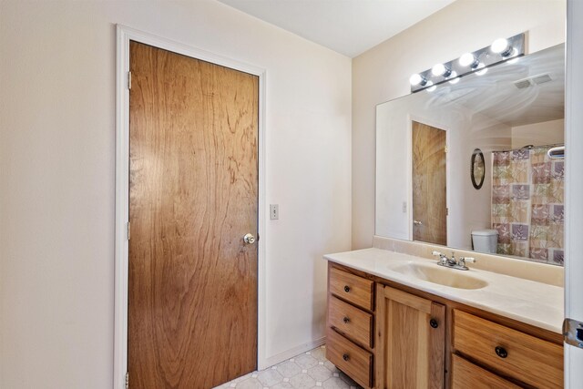 bathroom featuring vanity, toilet, and walk in shower