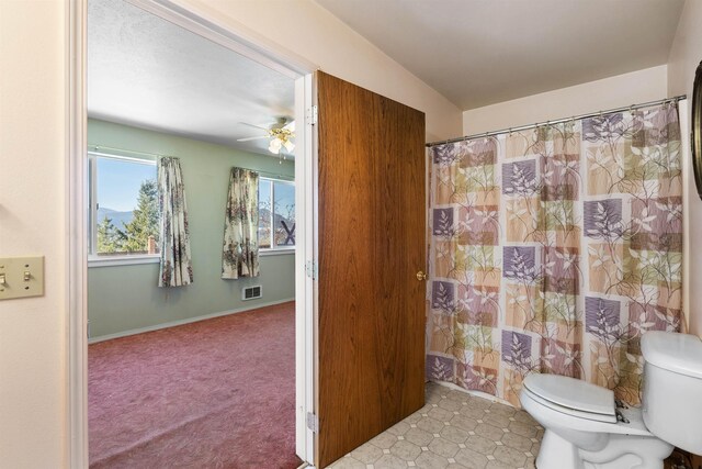 bathroom featuring ceiling fan and toilet