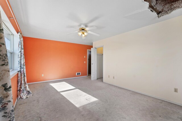 unfurnished living room featuring carpet floors and ceiling fan