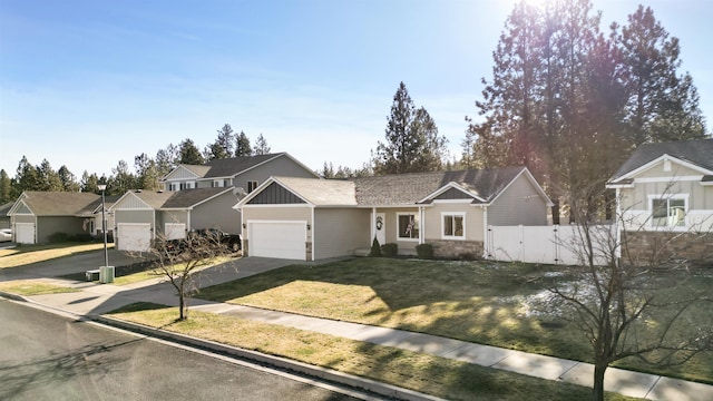 ranch-style house featuring a garage and a front yard