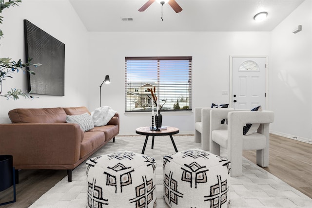 living room featuring ceiling fan and light wood-type flooring