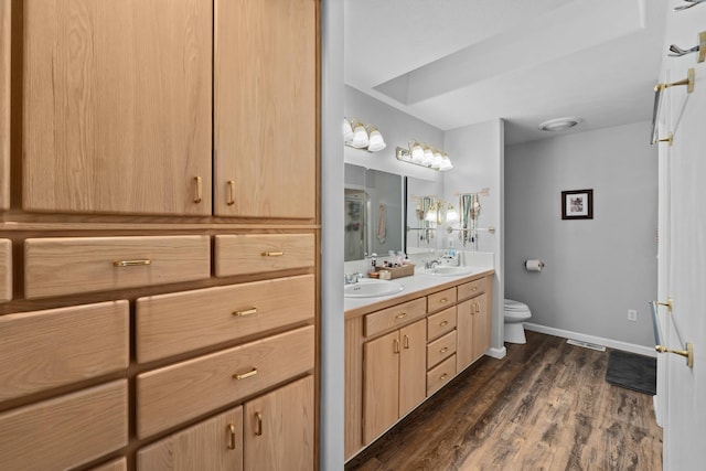 bathroom featuring vanity, toilet, and hardwood / wood-style floors