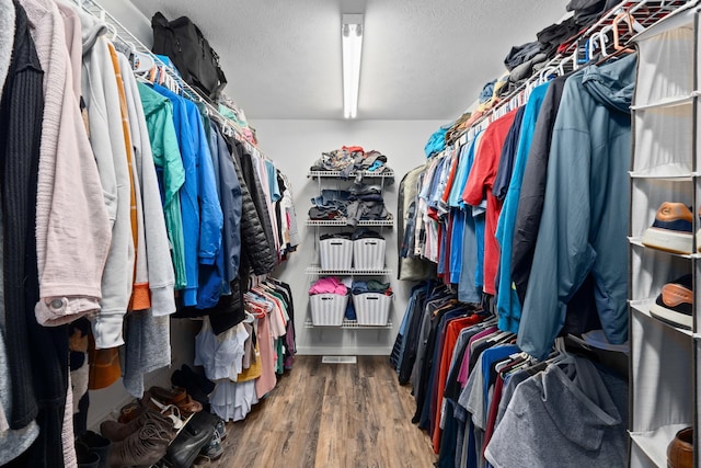 spacious closet featuring hardwood / wood-style floors