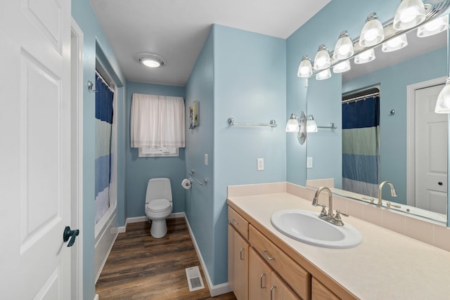 bathroom with hardwood / wood-style flooring, vanity, and toilet