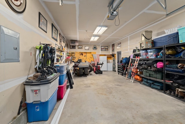 garage with white fridge, a garage door opener, electric panel, and a workshop area