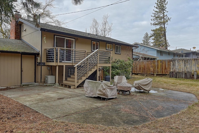 back of property with a patio area and an outdoor fire pit