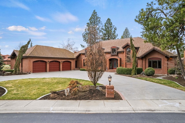 view of front of house with a garage and a front lawn