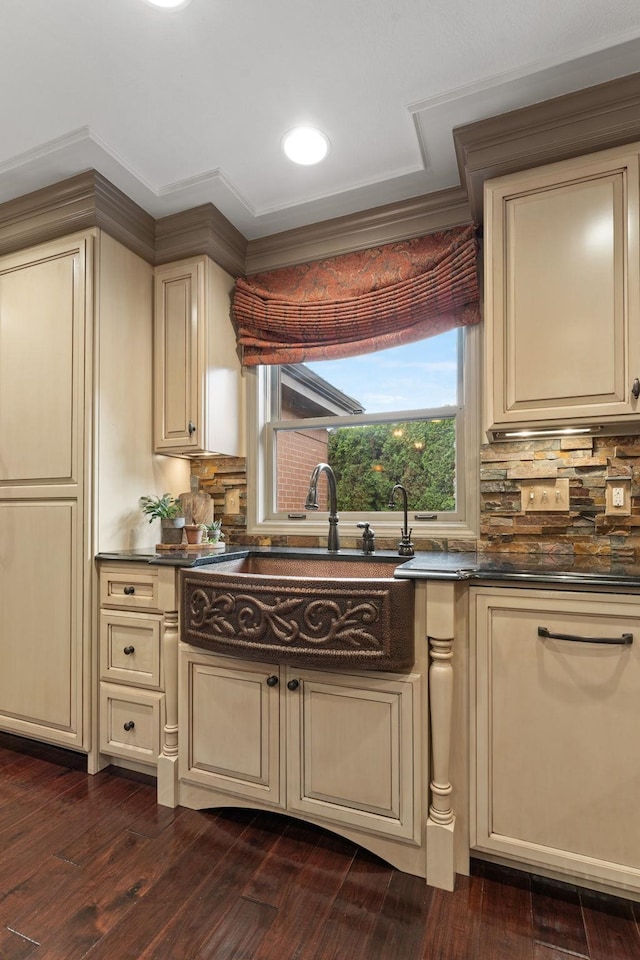 kitchen featuring dark wood-type flooring, sink, tasteful backsplash, and cream cabinetry