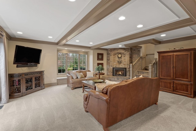 carpeted living room with beamed ceiling, ornamental molding, and a fireplace