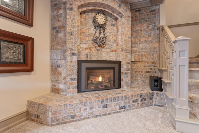 interior details with a fireplace and carpet flooring