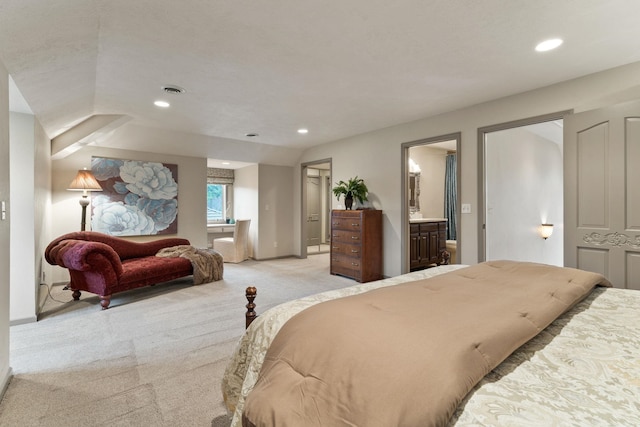 carpeted bedroom featuring ensuite bath