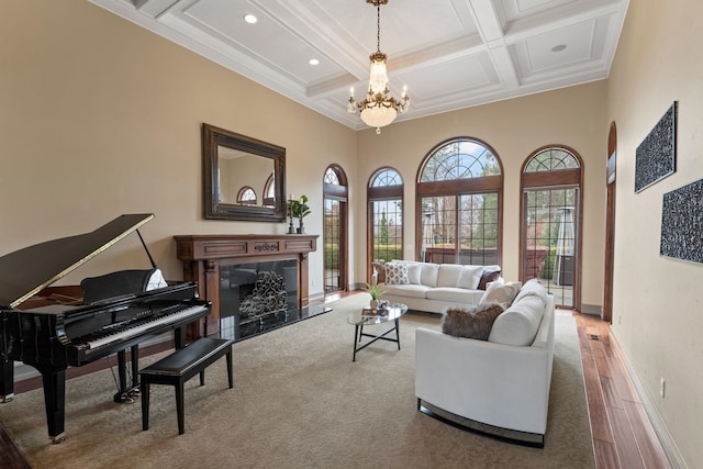 living room featuring coffered ceiling, beam ceiling, hardwood / wood-style flooring, a towering ceiling, and a premium fireplace