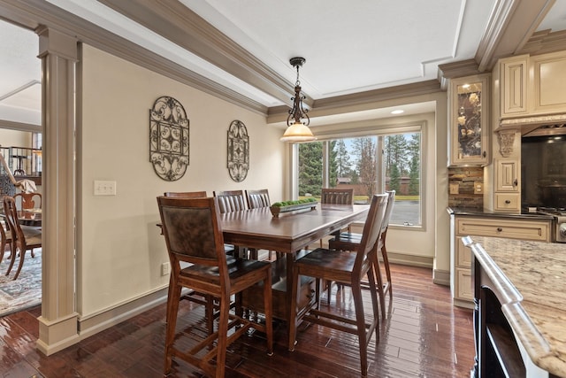 dining area with decorative columns, crown molding, and dark hardwood / wood-style floors