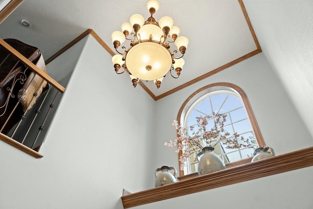 interior space featuring an inviting chandelier and crown molding