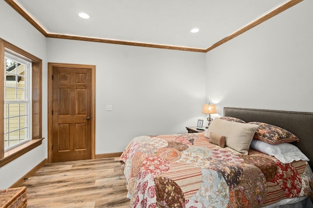 bedroom featuring ornamental molding and light wood-type flooring