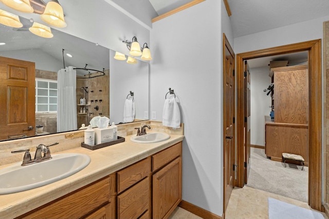 bathroom with a shower with curtain, vanity, and vaulted ceiling