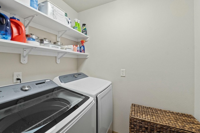 clothes washing area with washing machine and dryer