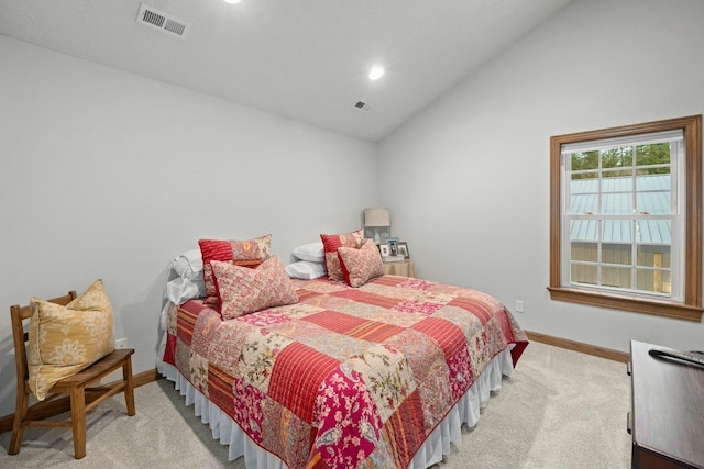 carpeted bedroom with lofted ceiling