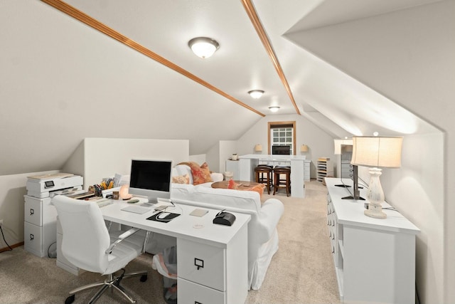 carpeted home office with lofted ceiling