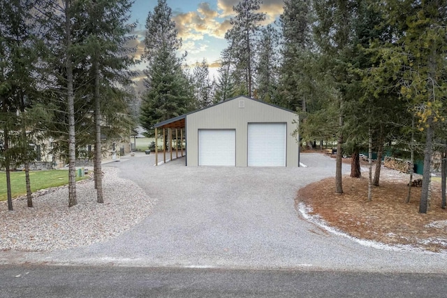 view of garage at dusk