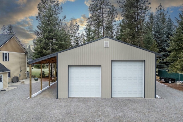 garage at dusk featuring central air condition unit
