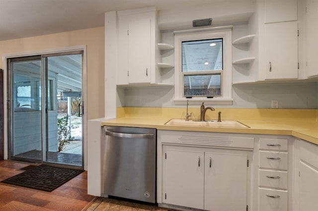 kitchen with a healthy amount of sunlight, sink, white cabinets, and dishwasher