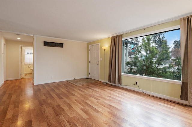 unfurnished room with light wood-type flooring