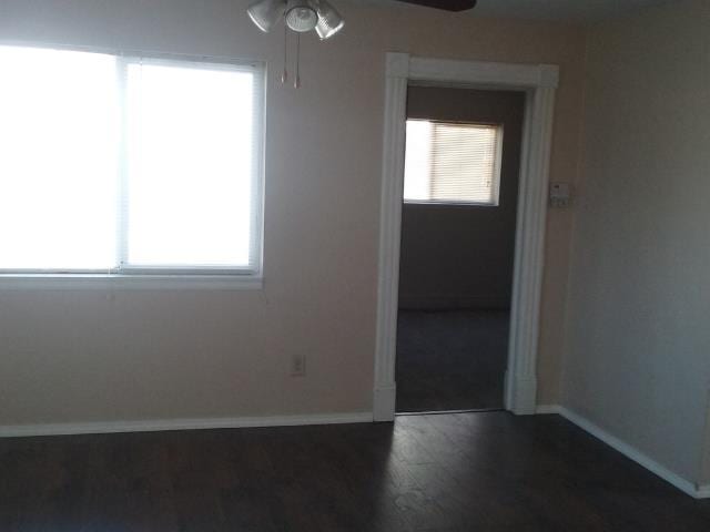 unfurnished room with dark wood-type flooring and ceiling fan