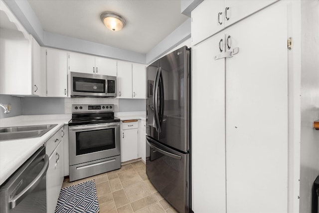 kitchen with sink, white cabinets, and appliances with stainless steel finishes