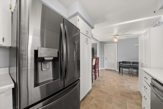 kitchen with ceiling fan, white cabinets, and appliances with stainless steel finishes