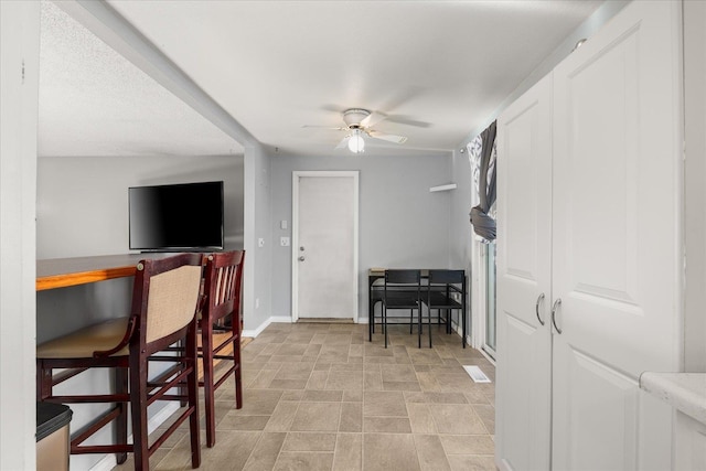 interior space featuring ceiling fan