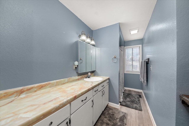 bathroom with vanity and wood-type flooring