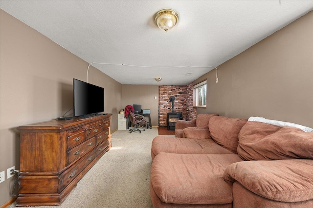 carpeted living room with a wood stove and a textured ceiling