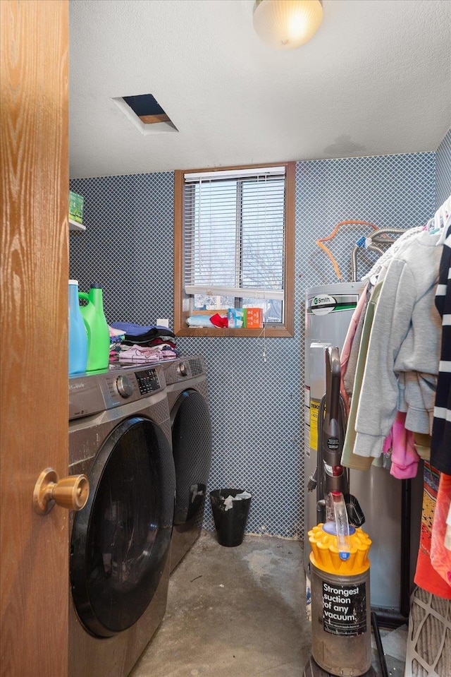 washroom with washer and dryer and a textured ceiling