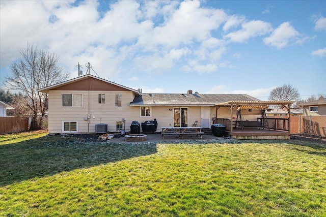 rear view of property with cooling unit, a yard, a pergola, and an outdoor fire pit