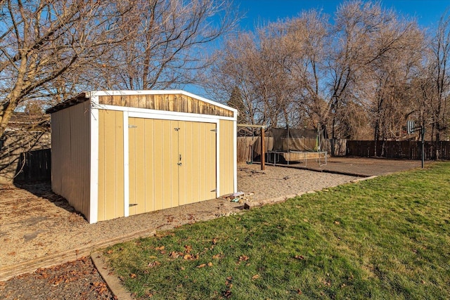 view of outbuilding with a yard and a trampoline