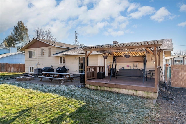 rear view of property with an outdoor fire pit, a yard, a pergola, cooling unit, and a deck