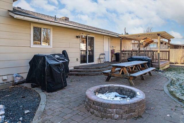 view of patio featuring a deck and a fire pit