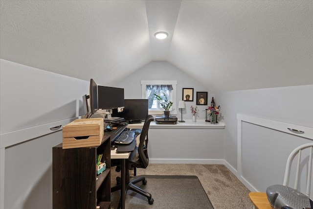 home office featuring vaulted ceiling, carpet floors, and a textured ceiling