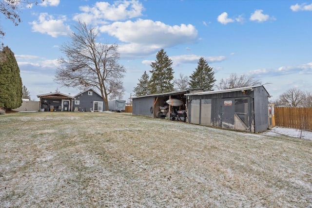 view of yard featuring a carport and an outdoor structure