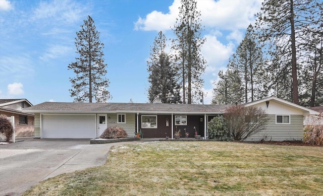 ranch-style home featuring a garage and a front lawn