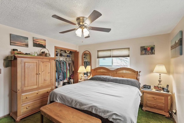 carpeted bedroom with ceiling fan, a textured ceiling, and a closet