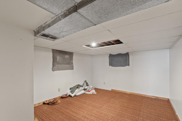 basement featuring a drop ceiling