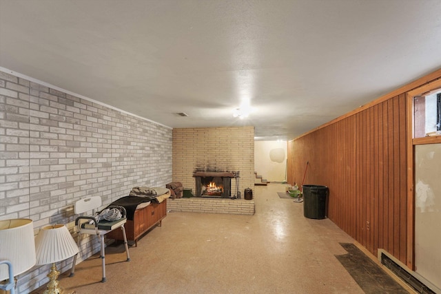 basement featuring brick wall, wooden walls, and a brick fireplace