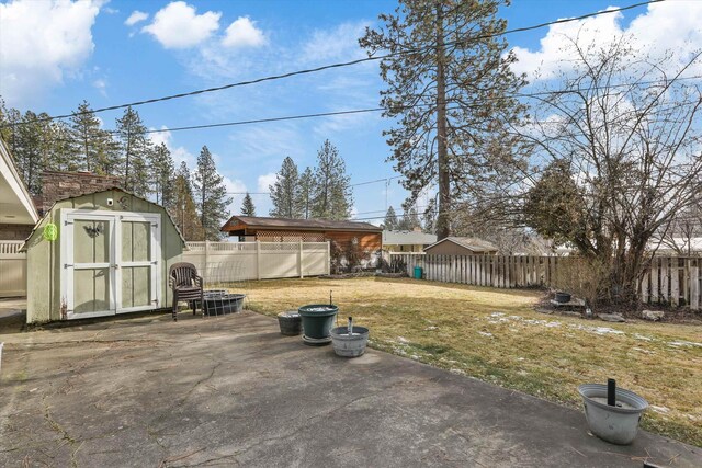 view of yard with a storage shed and a patio area