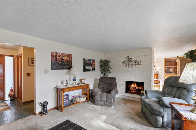 living room with a brick fireplace, carpet, and a textured ceiling